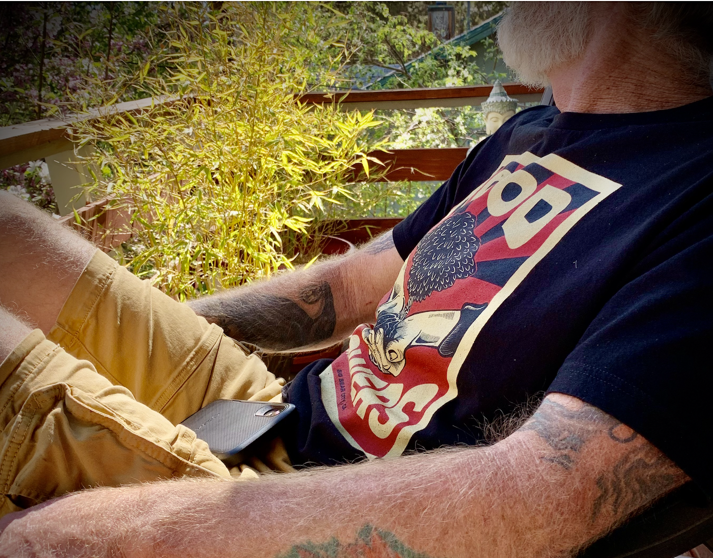 Man reclining in chair, Hood Growers Tshirt